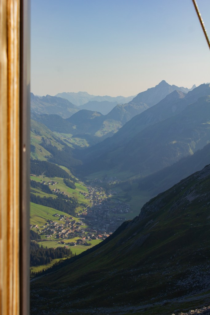 looking through the door of the Biwak down at Lech Austria